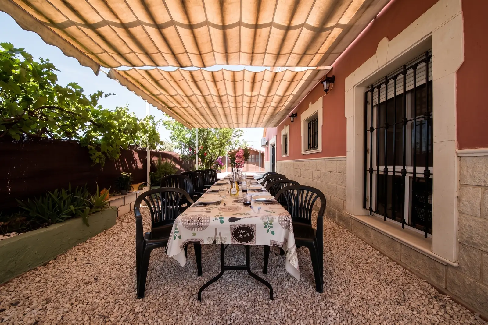 The long table laid for dinner under the lit canopy
